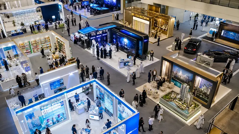 Multilingual exhibition staff assisting visitors across healthcare, technology, FMCG, and real estate exhibition booths