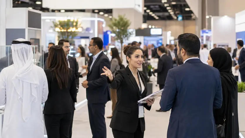 Professional exhibition staff assisting visitors during an exhibition in Abu Dhabi